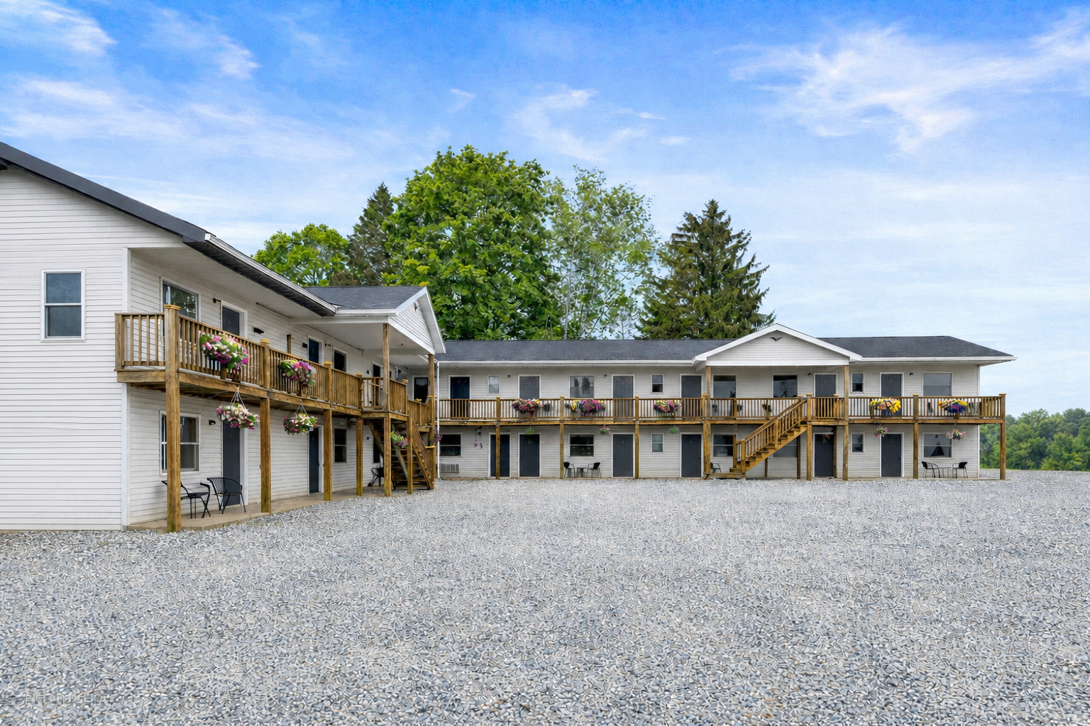 Renovated exterior of KC's Corner Motel with flower-lined balconies and guest-room entrances