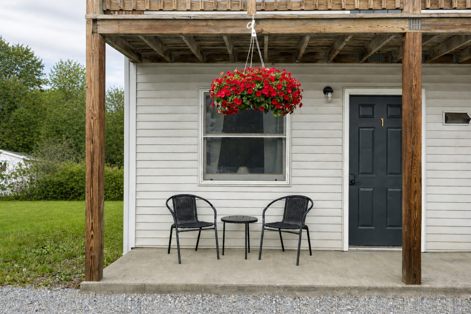 Private guest-room entrance at KC's Corner Motel with outdoor seating and flowers