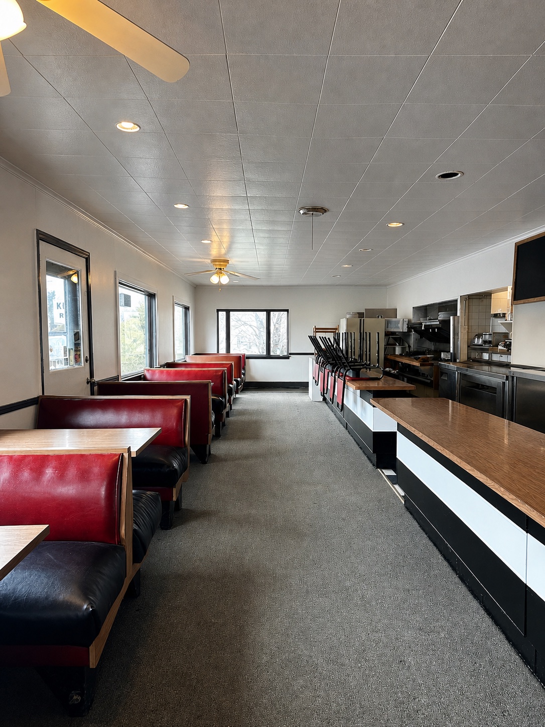 Original red booths and service counter inside KC's Corner Restaurant