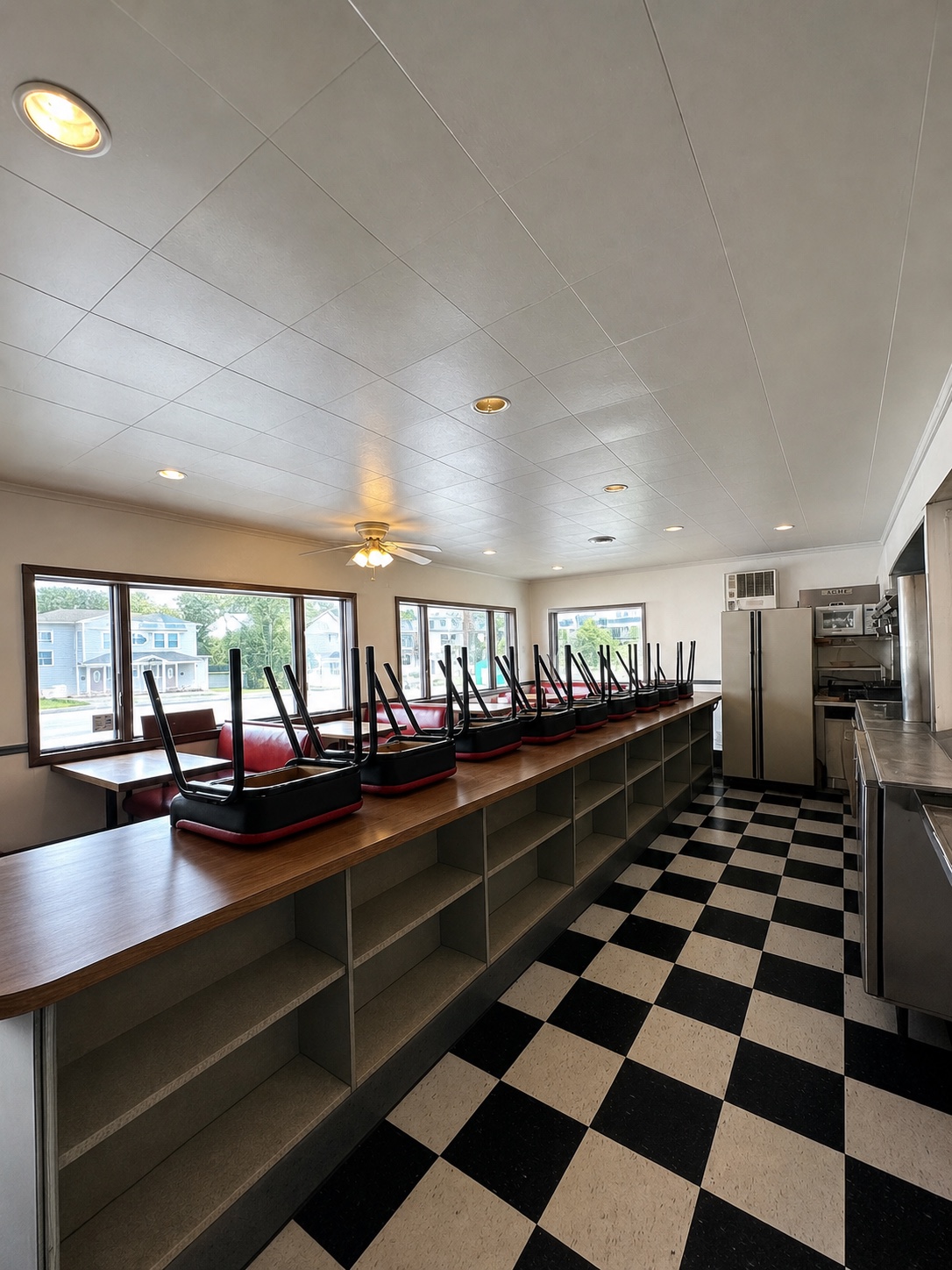 Restaurant kitchen service line with stainless equipment and preparation counters